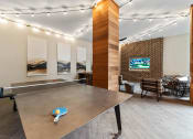 Thumbnail 20 of 41 - a game room with a ping pong table and a television