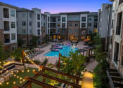 Thumbnail 1 of 41 - an aerial view of an apartment complex with a swimming pool at night
