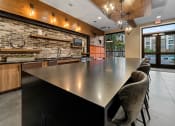 Thumbnail 9 of 41 - a large kitchen with a long counter and chairs