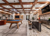 Thumbnail 13 of 41 - a game room with a pool table and a tv
