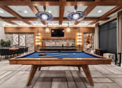 Thumbnail 11 of 41 - a games room with a pool table and a fireplace