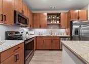 Thumbnail 21 of 41 - a kitchen with stainless steel appliances and marble counter tops