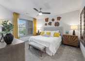 Thumbnail 28 of 41 - a bedroom with a bed and a ceiling fan