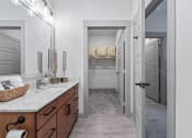 Thumbnail 31 of 41 - a bathroom with a sink and a door to a closet
