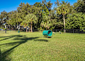 Thumbnail 24 of 32 - A green tube-like structure sits in a grassy field L'Estancia, Sarasota, FL, 34231
