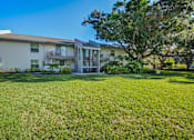 Thumbnail 30 of 32 - A two-story apartment building with a green lawn in front L'Estancia, Sarasota, FL, 34231