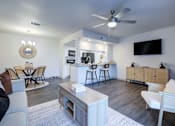 Thumbnail 5 of 32 - A modern living room with a white sofa, a coffee table, and a flat-screen TV mounted on the wall L'Estancia, Sarasota, FL, 34231