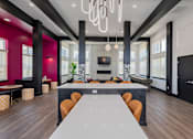 Thumbnail 31 of 49 - A modern dining room with a long table and chairs.