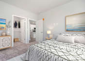 Thumbnail 24 of 49 - A bedroom with a large bed and a painting on the wall.