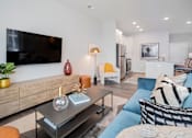 Thumbnail 15 of 49 - A modern living room with a flat screen TV mounted on the wall.