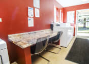 Thumbnail 15 of 43 - a kitchen with a counter and chairs and a sink