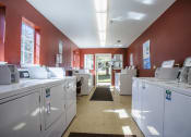 Thumbnail 16 of 43 - a laundry room with washing machines and dryers in it
