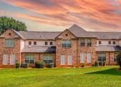 Thumbnail 66 of 69 - a large brick house with a lawn in front of it