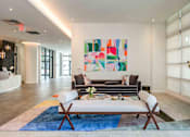 Thumbnail 12 of 18 - A modern living room with a large abstract painting on the wall.