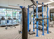 Thumbnail 14 of 18 - High-End Apartments In North Miami Beach, FL - Lazul - Fitness Center, Featuring Three Threadmills, Punching Bag, Weight Rack, Overhead Lighting, Rubber Matting, And Large Windows.