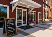 Thumbnail 39 of 40 - The entrance to Warren Mill Lofts with a sign welcoming people to the apartments.