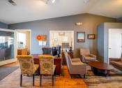 Thumbnail 3 of 43 - a living room with a dining room table and chairs