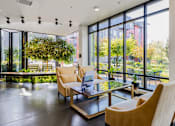 Thumbnail 8 of 27 - A living room with a glass table and chairs.