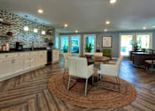 Thumbnail 1 of 35 - A kitchen with a stone wall and wooden floors.