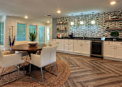 Thumbnail 2 of 35 - A modern dining room with a stone wall and wooden flooring.