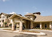 Thumbnail 1 of 18 - A large, well-maintained house with a spacious front yard.