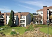 Thumbnail 31 of 33 - a view of a building with green grass and trees