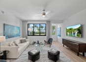 Thumbnail 51 of 78 - a living room with a couch and a table at Altis Blue Lake, Lake Worth, FL, 33467