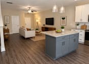 Thumbnail 18 of 71 - A modern kitchen with a large island and wooden floors.