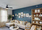 Thumbnail 37 of 56 - a living room with a blue accent wall and a white couch