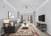 Thumbnail 12 of 29 - A living room with a grey couch, a rug, a ceiling fan, and a flat screen TV.