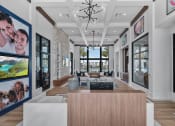 Thumbnail 4 of 78 - the living room has large windows and a large table and chairs at Altis Blue Lake, Lake Worth, 33467