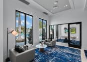 Thumbnail 9 of 78 - a living room with a view of a pool and a blue rug at Altis Blue Lake, Lake Worth, FL, 33467