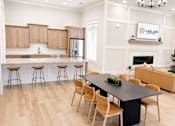 Thumbnail 2 of 35 - A modern kitchen with wooden cabinets and a black island.