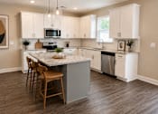 Thumbnail 12 of 71 - A Kitchen with island with natural stone countertops and bar top sitting