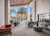 Thumbnail 13 of 27 - A patio with a table and chairs overlooking a balcony with palm trees.