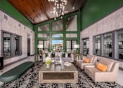 Thumbnail 22 of 27 - A modern living room with a green bench and a coffee table.
