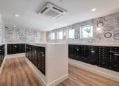 Thumbnail 32 of 78 - a walk in closet with a bunch of lockers and a wall covered in wallpaper at Altis Blue Lake, Florida, 33467