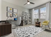 Thumbnail 13 of 31 - A room with a ceiling fan, a desk, a chair, and a rug with a pattern.
