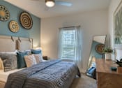 Thumbnail 23 of 49 - A bedroom with a large bed and a mirror on the dresser.