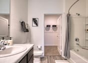 Thumbnail 35 of 49 - A bathroom with a white tub and a white toilet.