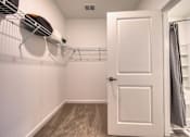 Thumbnail 36 of 49 - A white door is open to a bathroom.