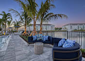 Thumbnail 5 of 49 - A patio with a couch and a pool.