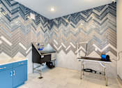 Thumbnail 17 of 49 - A bathroom with a blue and white chevron pattern on the wall.