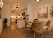 Thumbnail 40 of 40 - A modern kitchen with a dining table set for four.