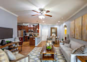 Thumbnail 1 of 28 - a living room with a couch and a ceiling fan