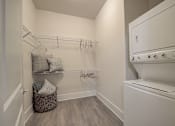 Thumbnail 32 of 53 - A laundry room with a washer and dryer.