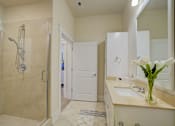 Thumbnail 29 of 53 - A bathroom with a white sink and a white shower.