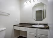 Thumbnail 7 of 28 - A bathroom with a white tub, sink, and mirror.