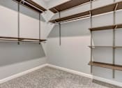 Thumbnail 20 of 31 - Empty room with shelving units and grey carpet.