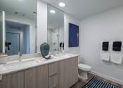 Thumbnail 22 of 78 - a bathroom with a sink and a toilet and a mirror at Altis Blue Lake, Lake Worth, FL, 33467
